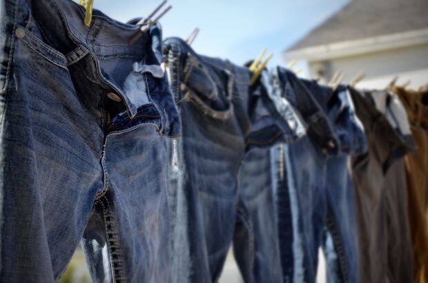 A,Side,View,Image,Of,Freshly,Washed,Denim,Jeans,Hanging