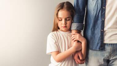 Charming,Little,Girl,Is,Holding,Her,Father's,Hand,,On,Gray