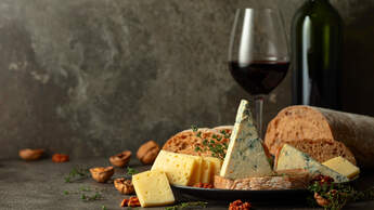 Cheese,,Bread,,Red,Wine,,And,Walnuts,On,A,Kitchen,Table.