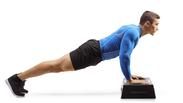 Muscular,Man,Exercising,Push-ups,On,A,Step,Aerobic,Platform,Isolated