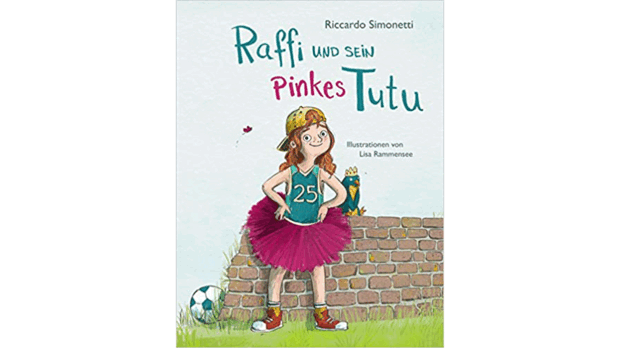 Bạn có thể xem bìa sách thiếu nhi "Raffi và Tutu màu hồng của anh ấy" của Riccardo Simonetti.  Nhân vật chính Raffi mặc áo phông màu hồng, đội mũ lưỡi trai và mặc áo bóng đá và đứng trước một bức tường. 